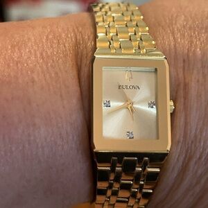 Gold and diamond Bulova watch.